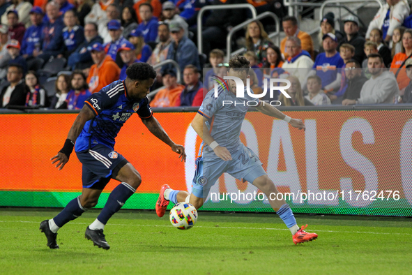 Cincinnati's Alvas Powell and New York's Kevin O'Toole compete for the ball during the 2024 MLS Cup Playoffs Round One match between FC Cinc...