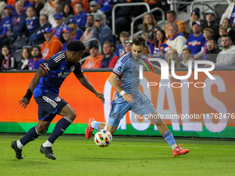 Cincinnati's Alvas Powell and New York's Kevin O'Toole compete for the ball during the 2024 MLS Cup Playoffs Round One match between FC Cinc...