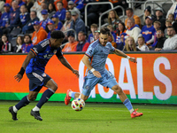 Cincinnati's Alvas Powell and New York's Kevin O'Toole compete for the ball during the 2024 MLS Cup Playoffs Round One match between FC Cinc...