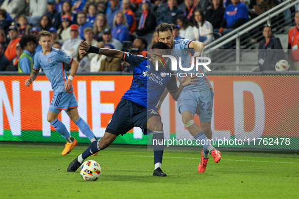 Cincinnati's Alvas Powell and New York's Kevin O'Toole compete for the ball during the 2024 MLS Cup Playoffs Round One match between FC Cinc...