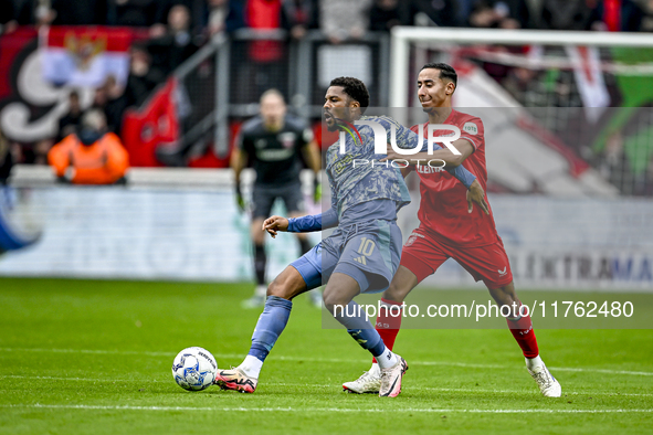 AFC Ajax Amsterdam forward Chuba Akpom and FC Twente defender Anass Salah-Eddine play during the match between Twente and Ajax at the Grolsc...