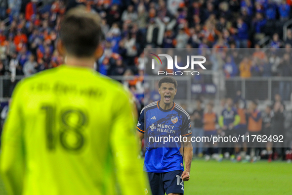 Miles Robinson gestures to goalie Roman Celentano after scoring a penalty kick during the 2024 MLS Cup Playoffs Round One match between FC C...