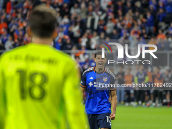 Miles Robinson gestures to goalie Roman Celentano after scoring a penalty kick during the 2024 MLS Cup Playoffs Round One match between FC C...