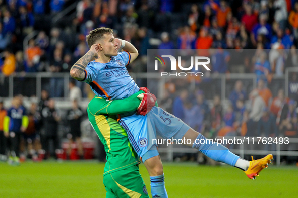 New York goalie Matt Freese lifts teammate Mitja Ilenic after scoring the decisive penalty kick during the 2024 MLS Cup Playoffs Round One m...