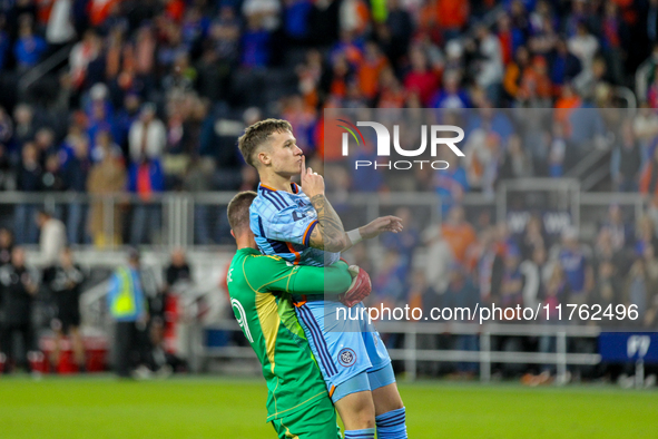 New York goalie Matt Freese lifts teammate Mitja Ilenic after scoring the decisive penalty kick during the 2024 MLS Cup Playoffs Round One m...