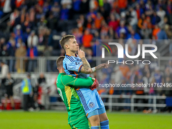 New York goalie Matt Freese lifts teammate Mitja Ilenic after scoring the decisive penalty kick during the 2024 MLS Cup Playoffs Round One m...