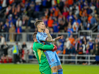 New York goalie Matt Freese lifts teammate Mitja Ilenic after scoring the decisive penalty kick during the 2024 MLS Cup Playoffs Round One m...