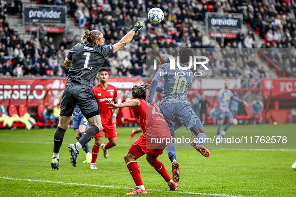 FC Twente goalkeeper Lars Unnerstall and AFC Ajax Amsterdam forward Chuba Akpom participate in the match between Twente and Ajax at the Grol...