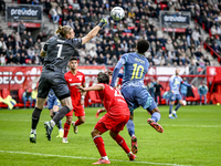 FC Twente goalkeeper Lars Unnerstall and AFC Ajax Amsterdam forward Chuba Akpom participate in the match between Twente and Ajax at the Grol...