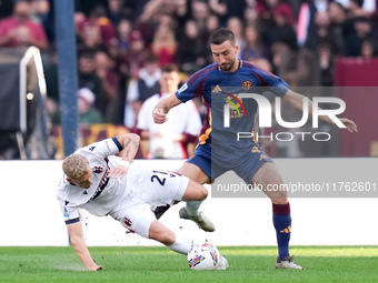 Jens Odgaard of Bologna FC and Bryan Cristante of AS Roma compete for the ball during the Serie A Enilive match between AS Roma and Bologna...