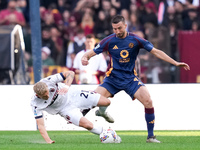 Jens Odgaard of Bologna FC and Bryan Cristante of AS Roma compete for the ball during the Serie A Enilive match between AS Roma and Bologna...