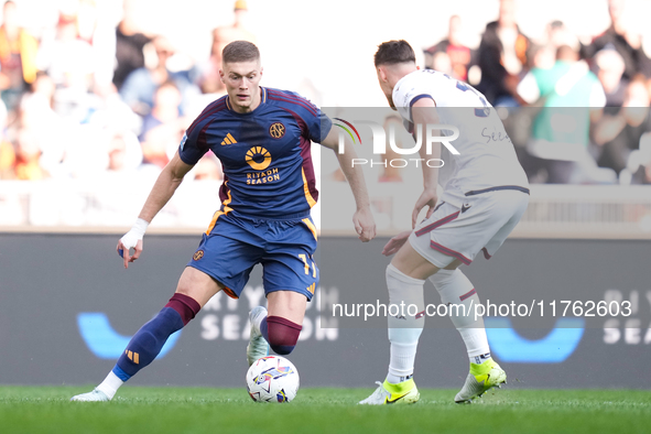 Artem Dovbyk of AS Roma and Juan Miranda of Bologna FC compete for the ball during the Serie A Enilive match between AS Roma and Bologna FC...