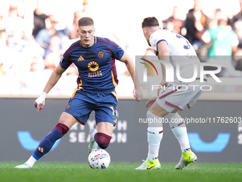 Artem Dovbyk of AS Roma and Juan Miranda of Bologna FC compete for the ball during the Serie A Enilive match between AS Roma and Bologna FC...