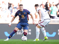 Artem Dovbyk of AS Roma and Juan Miranda of Bologna FC compete for the ball during the Serie A Enilive match between AS Roma and Bologna FC...