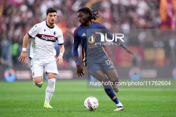 Manu Kone' of AS Roma and Riccardo Orsolini of Bologna FC during the Serie A Enilive match between AS Roma and Bologna FC at Stadio Olimpico...