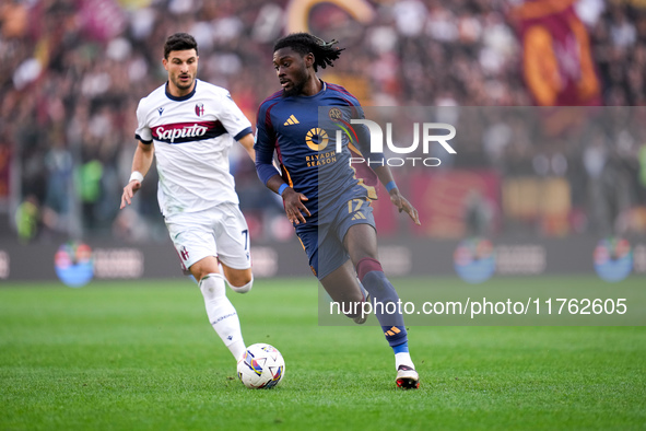 Manu Kone' of AS Roma and Riccardo Orsolini of Bologna FC during the Serie A Enilive match between AS Roma and Bologna FC at Stadio Olimpico...