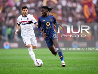 Manu Kone' of AS Roma and Riccardo Orsolini of Bologna FC during the Serie A Enilive match between AS Roma and Bologna FC at Stadio Olimpico...