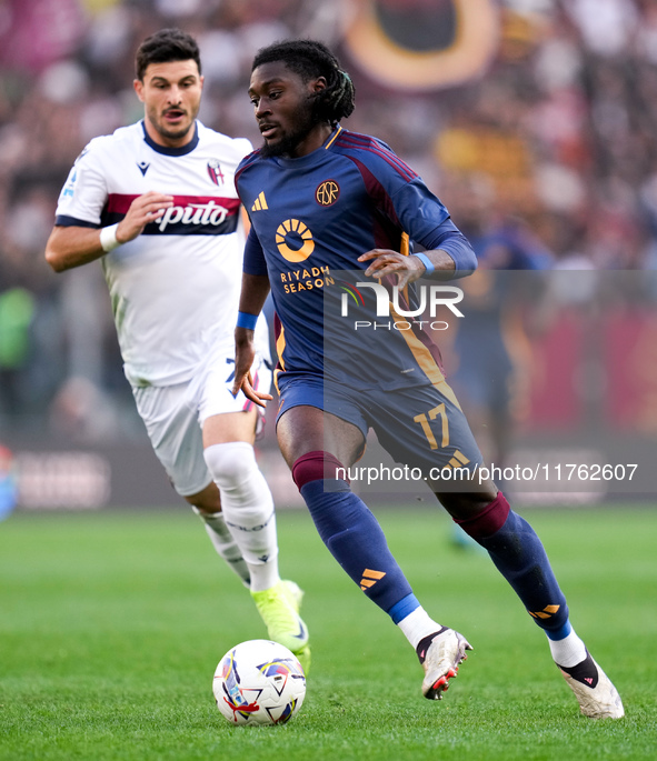 Manu Kone' of AS Roma and Riccardo Orsolini of Bologna FC during the Serie A Enilive match between AS Roma and Bologna FC at Stadio Olimpico...