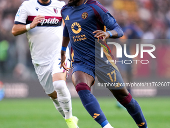 Manu Kone' of AS Roma and Riccardo Orsolini of Bologna FC during the Serie A Enilive match between AS Roma and Bologna FC at Stadio Olimpico...