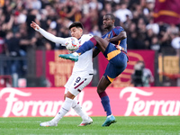 Evan Ndicka of AS Roma and Santiago Castro of Bologna FC compete for the ball during the Serie A Enilive match between AS Roma and Bologna F...