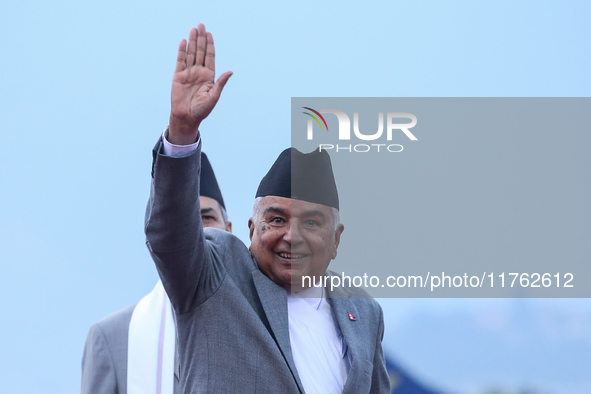 Nepal's President Ram Chandra Paudel waves at the media as he departs for Baku to represent Nepal in COP-29 at the VVIP Terminal of Tribhuva...