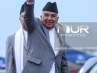 Nepal's President Ram Chandra Paudel waves at the media as he departs for Baku to represent Nepal in COP-29 at the VVIP Terminal of Tribhuva...