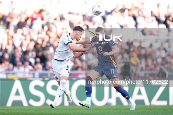 Artem Dovbyk of AS Roma and Sam Beukema of Bologna FC compete for the ball during the Serie A Enilive match between AS Roma and Bologna FC a...