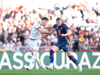 Artem Dovbyk of AS Roma and Sam Beukema of Bologna FC compete for the ball during the Serie A Enilive match between AS Roma and Bologna FC a...