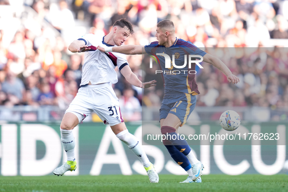 Artem Dovbyk of AS Roma and Sam Beukema of Bologna FC compete for the ball during the Serie A Enilive match between AS Roma and Bologna FC a...