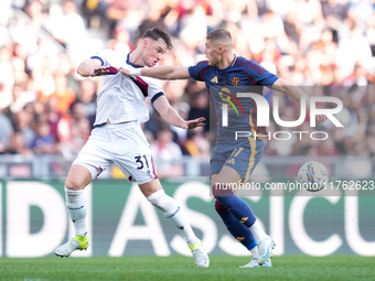 Artem Dovbyk of AS Roma and Sam Beukema of Bologna FC compete for the ball during the Serie A Enilive match between AS Roma and Bologna FC a...