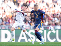 Artem Dovbyk of AS Roma and Sam Beukema of Bologna FC compete for the ball during the Serie A Enilive match between AS Roma and Bologna FC a...