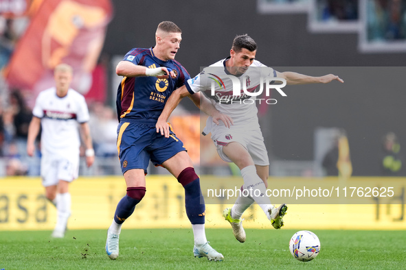 Artem Dovbyk of AS Roma and Remo Freuler of Bologna FC compete for the ball during the Serie A Enilive match between AS Roma and Bologna FC...