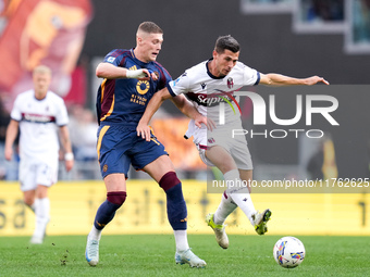 Artem Dovbyk of AS Roma and Remo Freuler of Bologna FC compete for the ball during the Serie A Enilive match between AS Roma and Bologna FC...