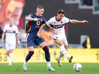 Artem Dovbyk of AS Roma and Remo Freuler of Bologna FC compete for the ball during the Serie A Enilive match between AS Roma and Bologna FC...