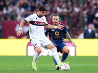 Riccardo Orsolini of Bologna FC and Angelino of AS Roma compete for the ball during the Serie A Enilive match between AS Roma and Bologna FC...