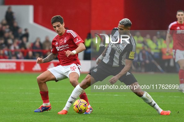 Nicolas Dominguez of Nottingham Forest battles with Joelinton of Newcastle United during the Premier League match between Nottingham Forest...