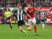 Chris Wood of Nottingham Forest puts pressure on Dan Burn of Newcastle United during the Premier League match between Nottingham Forest and...