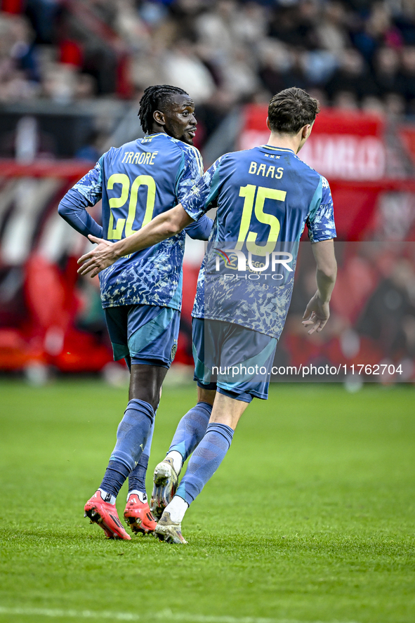 AFC Ajax Amsterdam forward Bertrand Traore and AFC Ajax Amsterdam defender Youri Baas celebrate the 2-2 goal during the match between Twente...