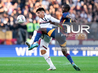 Santiago Castro of Bologna FC and Evan Ndicka of AS Roma compete for the ball during the Serie A Enilive match between AS Roma and Bologna F...