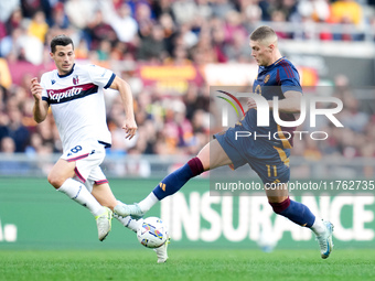 Remo Freuler of Bologna FC and Artem Dovbyk of AS Roma compete for the ball during the Serie A Enilive match between AS Roma and Bologna FC...