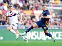 Remo Freuler of Bologna FC and Artem Dovbyk of AS Roma compete for the ball during the Serie A Enilive match between AS Roma and Bologna FC...