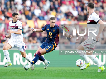 Remo Freuler of Bologna FC and Artem Dovbyk of AS Roma compete for the ball during the Serie A Enilive match between AS Roma and Bologna FC...