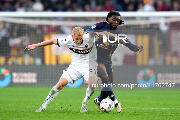 Jens Odgaard of Bologna FC and Manu Kone' of AS Roma compete for the ball during the Serie A Enilive match between AS Roma and Bologna FC at...