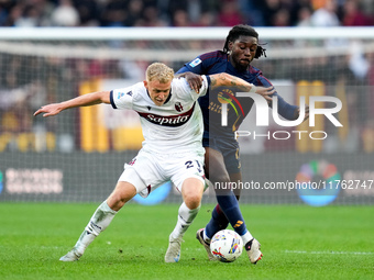 Jens Odgaard of Bologna FC and Manu Kone' of AS Roma compete for the ball during the Serie A Enilive match between AS Roma and Bologna FC at...