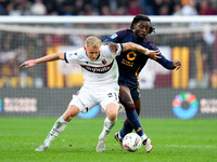 Jens Odgaard of Bologna FC and Manu Kone' of AS Roma compete for the ball during the Serie A Enilive match between AS Roma and Bologna FC at...