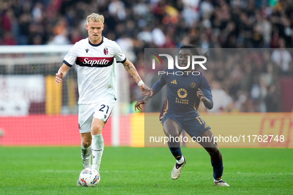 Manu Kone' of AS Roma and Jens Odgaard of Bologna FC compete for the ball during the Serie A Enilive match between AS Roma and Bologna FC at...