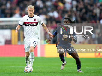 Manu Kone' of AS Roma and Jens Odgaard of Bologna FC compete for the ball during the Serie A Enilive match between AS Roma and Bologna FC at...