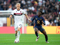 Manu Kone' of AS Roma and Jens Odgaard of Bologna FC compete for the ball during the Serie A Enilive match between AS Roma and Bologna FC at...