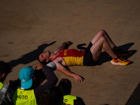 A marathon runner lies on the ground immediately after finishing the Athens Marathon in Athens, Greece, on November 10, 2024 (