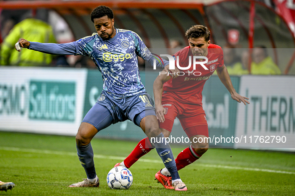 AFC Ajax Amsterdam forward Chuba Akpom and FC Twente defender Bart van Rooij participate in the match between Twente and Ajax at the Grolsch...